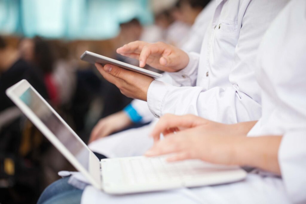 doctors with laptops in seminar