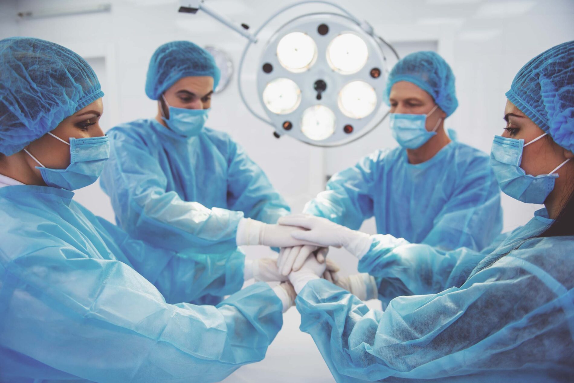 team of surgeons stacking hands