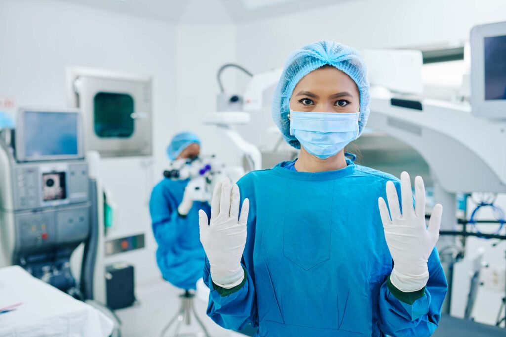 women surgeon wearing medical gloves