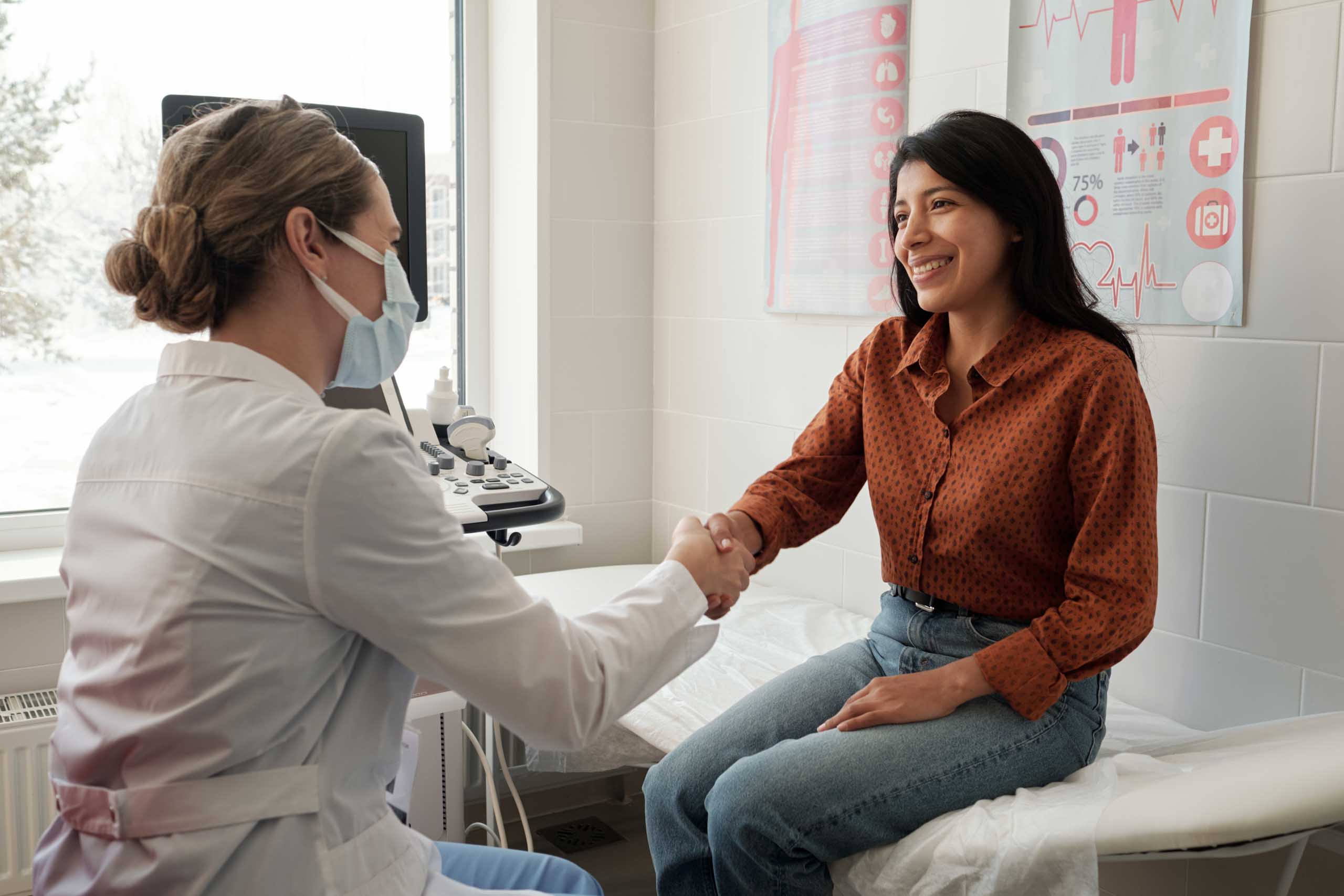 doctor shaking a smiling patient's hand