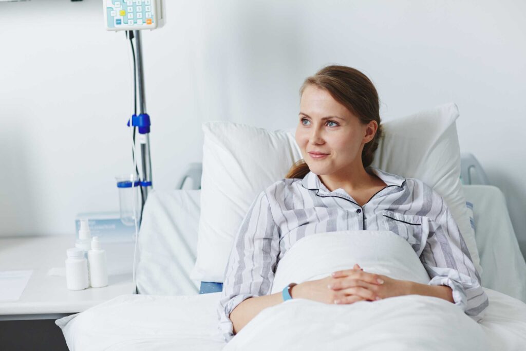 smiling patient in hospital bed