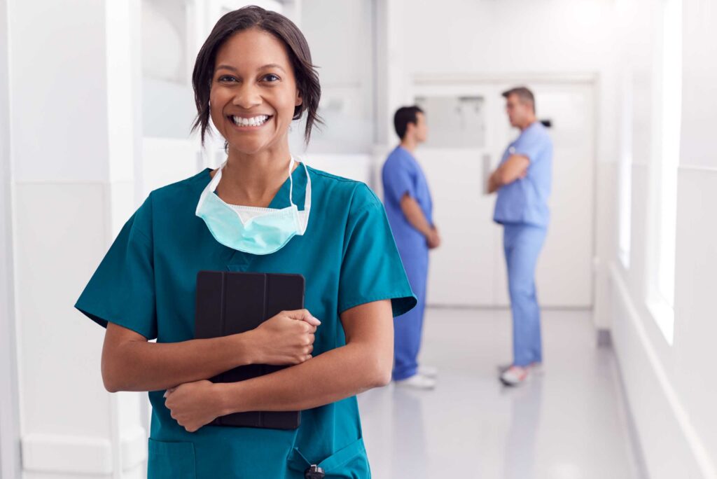 smiling female doctor wearing scrubs in a hospital